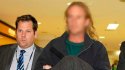 Police escort Scott Allen Miller at Tullamarine airport Tuesday. Photo Angela Wylie.jpg