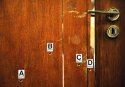 CLOSE UP toilet door bullet holes.jpg