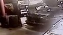 Red hoodie person reaching in back, and disappearing behind pump.jpg