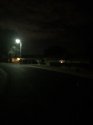 house with street lamp in front a couple of houses down on same side of street still very dark.jpg