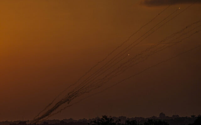 Rockets are fired toward Israel from the Gaza Strip, as seen from southern Israel, Sunday, Oct. 15, 2023.  (AP Photo/Ariel Schalit)