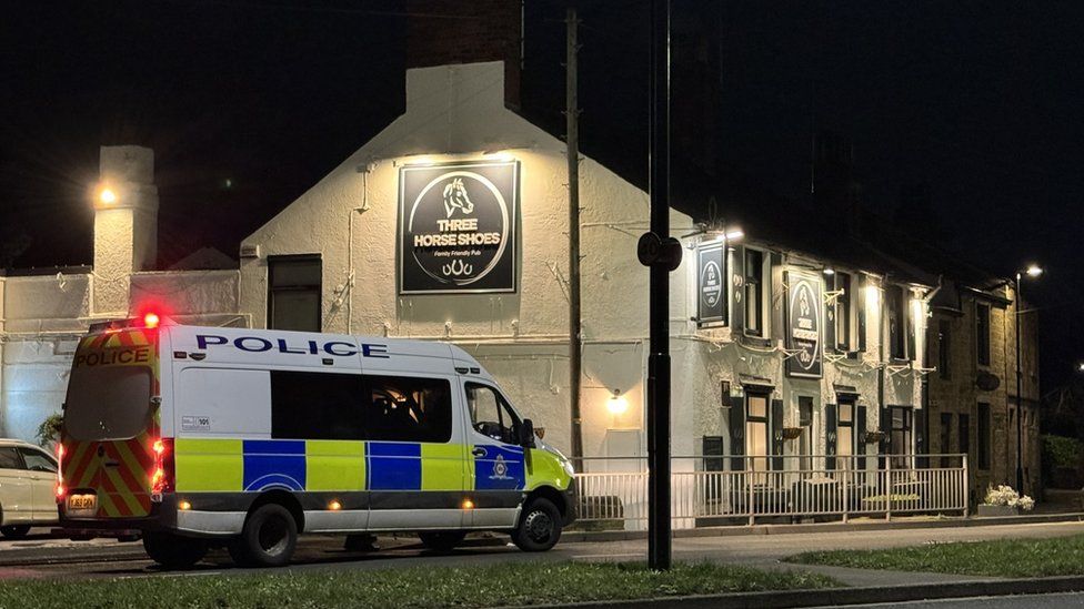 Police van outside Three Horseshoes pub