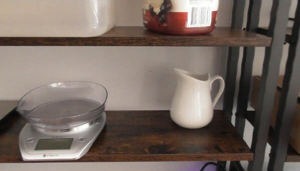 Scales and a jug on a counter.