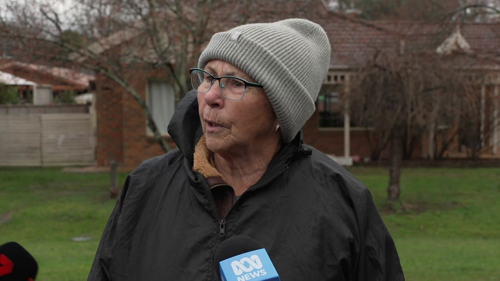 A woman in coat and beanie speaks about alleged gunman Dezi Freeman.