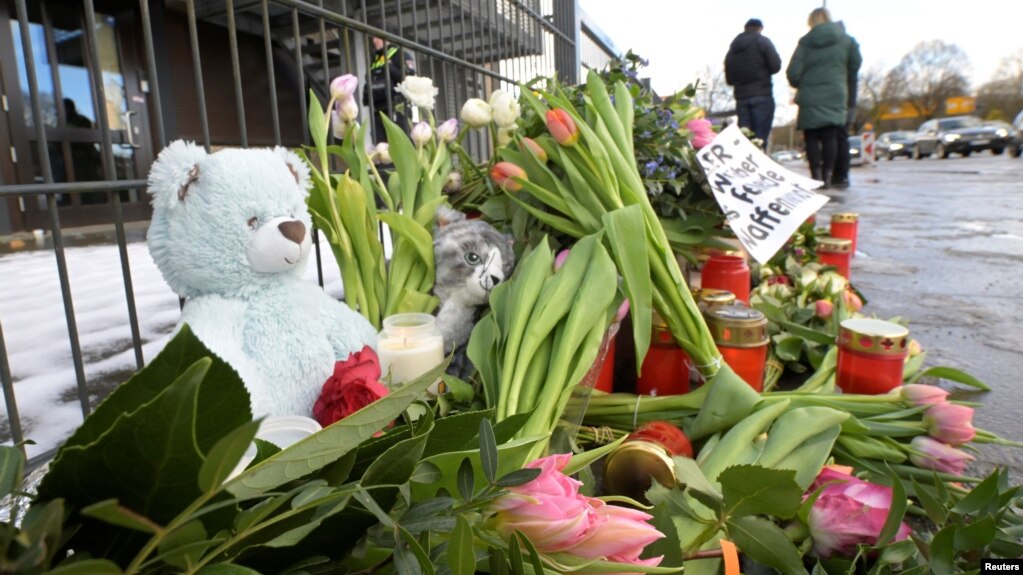 FILE - Flowers sit near the site of a deadly shooting at a Kingdom Hall of Jehovah's Witnesses in Hamburg, Germany, March 11, 2023. Members held a memorial service Saturday for the six people killed in the shooting.