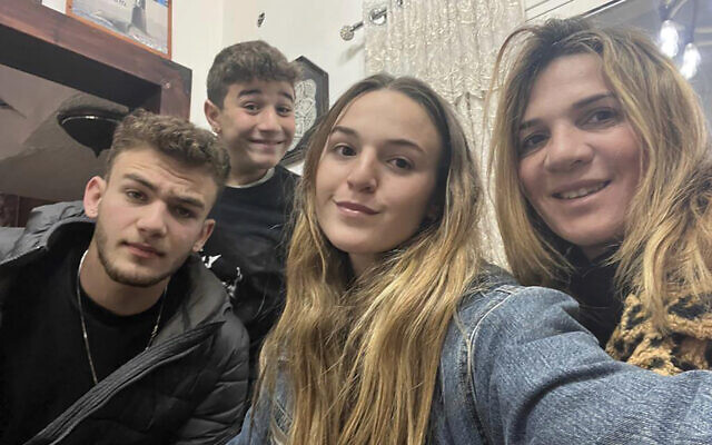 This undated family photo provided on October 16, 2023, shows Maya Regev, 21, center, and Itay Regev, 18, left, with their mother and a brother. (Regev family via AP)