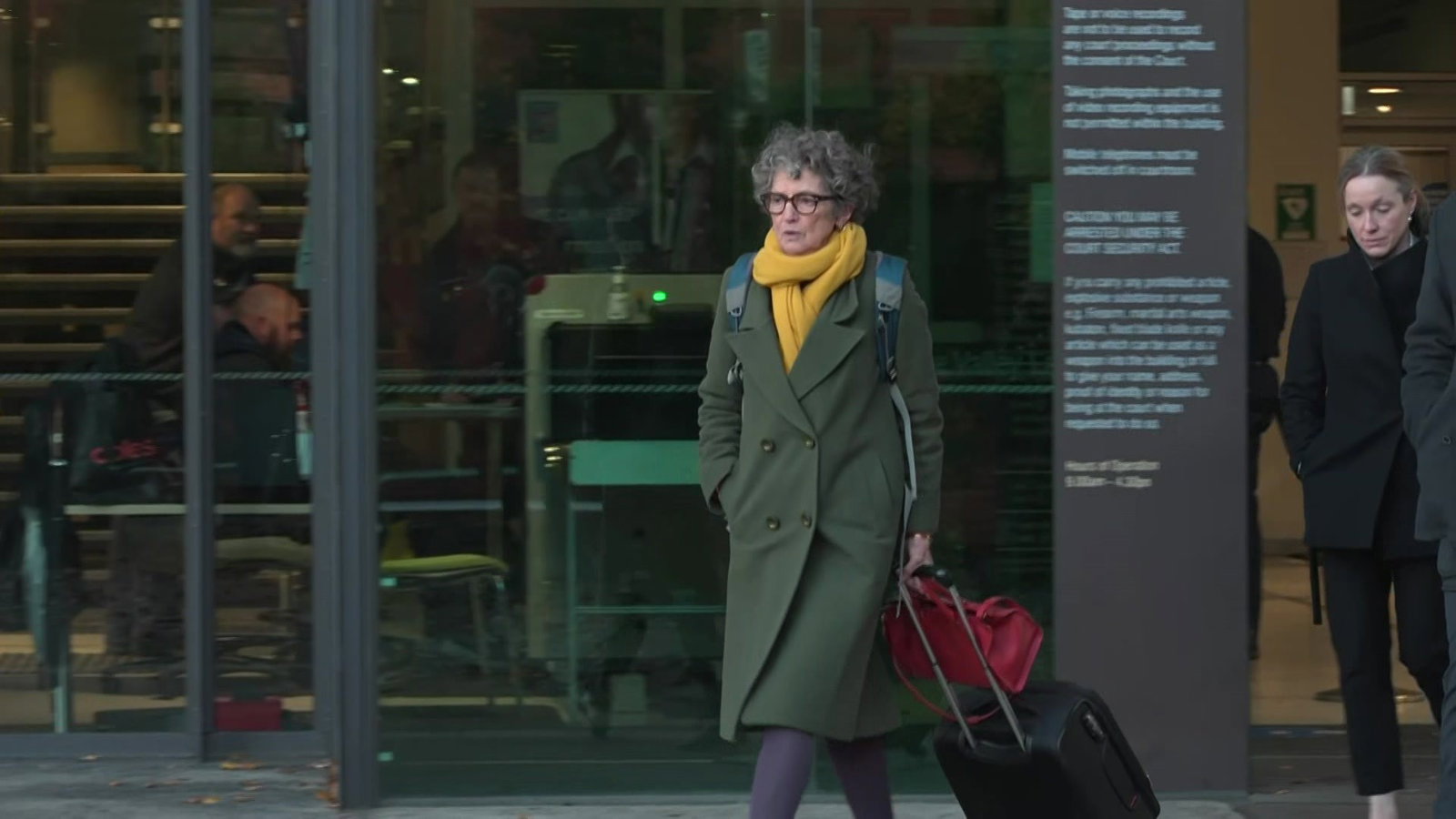 A woman leaving a courtroom
