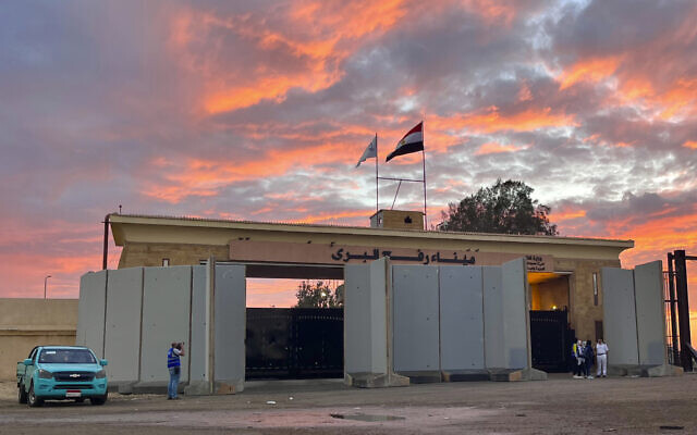 Policemen stand at Rafah crossing port, Egypt, as humanitarian aid convoy for the Gaza Strip is parked Oct. 17, 2023. (AP Photo/Omar Aziz)