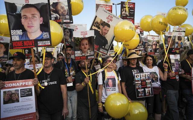 Family and supporters of the estimated 240 hostages held by Hamas in Gaza complete the final leg of a five-day solidarity rally calling for their return, from Tel Aviv to the Prime Minister's Office in Jerusalem, November 18, 2023. (AP/Mahmoud Illean)