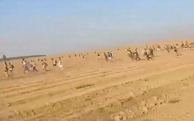 Hundreds flee gunmen at a music festival near Kibbutz Re'im, October 7, 2023. (Used in accordance with Clause 27a of the Copyright Law)'im, October 7, 2023. (Used in accordance with Clause 27a of the Copyright Law)