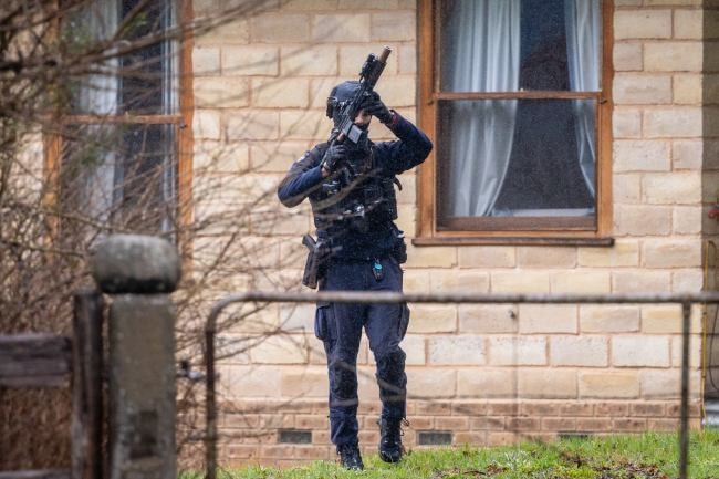 Heavily armed police searched the property. Picture: Jason Edwards