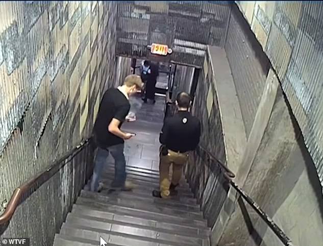 Strain appears to be unsteady on his feet as talks to the guard while they walk down the stairs from the roof top bar