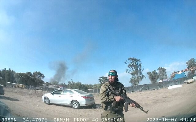 An armed Hamas terrorist walking around the Supernova music festival, near Kibbutz Reim in the Negev desert in southern Israel on October 7, where terrorists from Gaza massacred hundreds of people. (SOUTH FIRST RESPONDERS / AFP) An armed Hamas terrorist walking around the Supernova music festival, near Kibbutz Reim in the Negev desert in southern Israel on October 7, where terrorists from Gaza massacred hundreds of people. (SOUTH FIRST RESPONDERS / AFP)