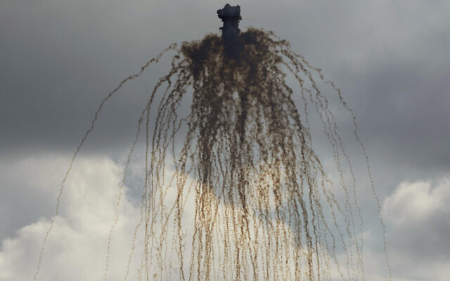 A shell from Israeli artillery explodes over al-Bustan, a Lebanese border village with Israel, south Lebanon, Sunday, Oct. 15, 2023. (AP Photo/Hussein Malla)