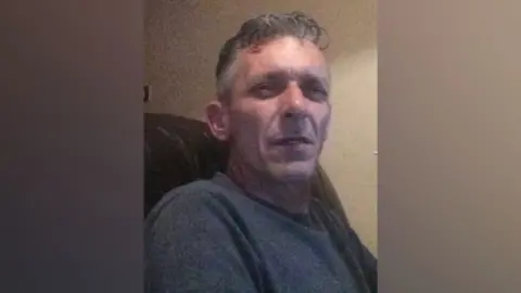 South Yorkshire Police A 58-year-old white male wearing a grey jumper.