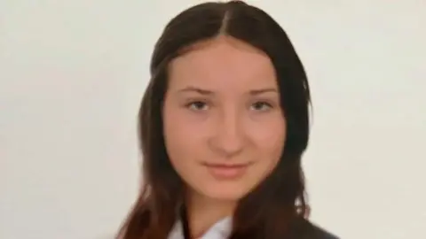 Family handout A school photo of Scarlett Vickers smiling into the camera. She has dark, long hair and dark eyes.