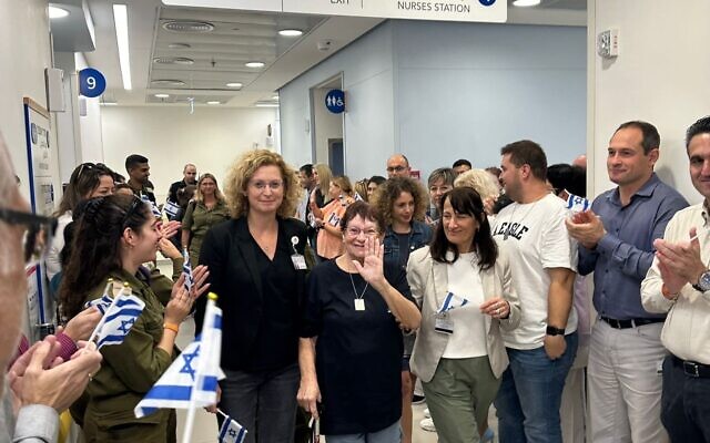 Channah Peri, center, waves as she leaves the Wolfson Medical Center on November 26, 2023, after she was released from Gaza captivity two days earlier. (Courtesy)