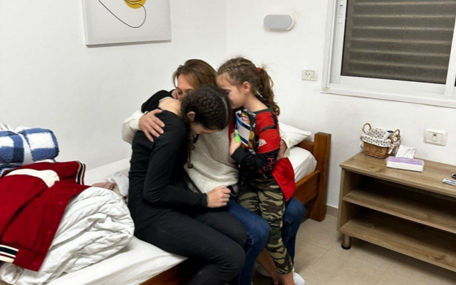 Maayan Zin embraces her daughters, Dafna, and Ela, after they were released from Gaza captivity on November 26, 2023. (Courtesy)