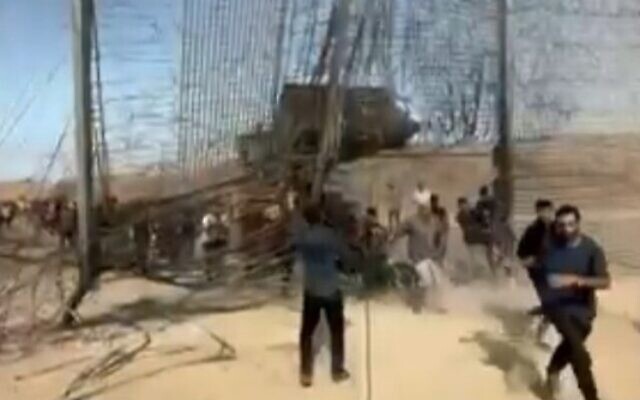 Terrorists burst through the border fence from Gaza into Israel on October 7, 2023. (Channel 12 screenshot; used in accordance with Clause 27a of the copyright law) Terrorists burst through the border fence from Gaza into Israel on October 7, 2023. (Channel 12 screenshot; used in accordance with Clause 27a of the copyright law)